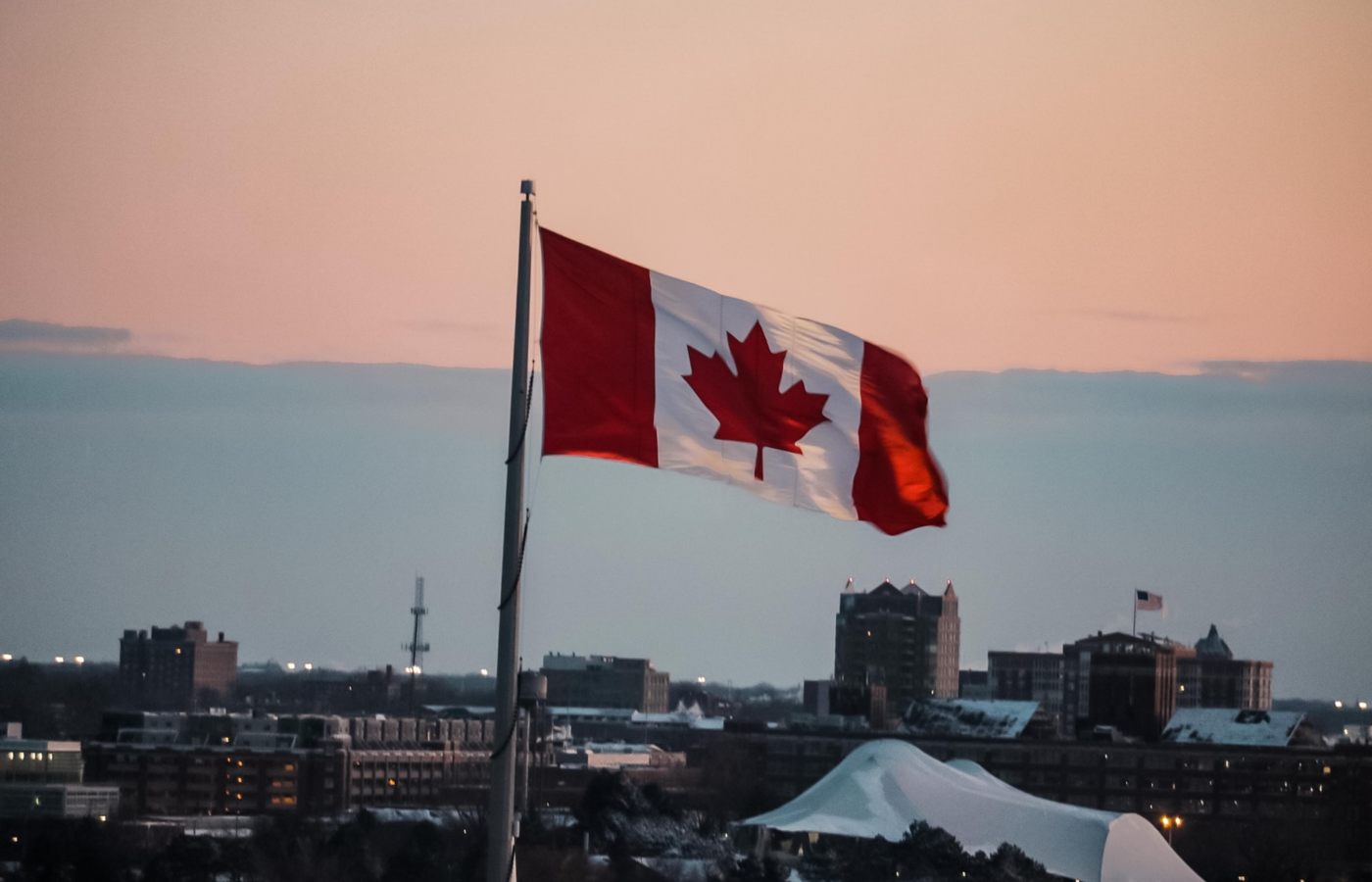 Bandeira do Canadá hasteada ao céu no fim da tarde